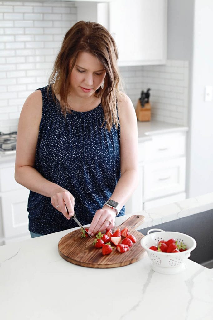woman chopping strawberries