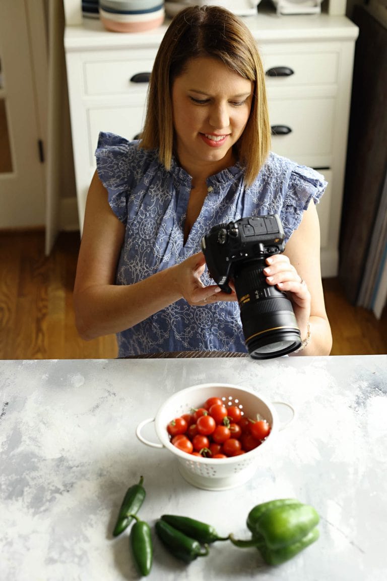 woman with camera taking photos of food