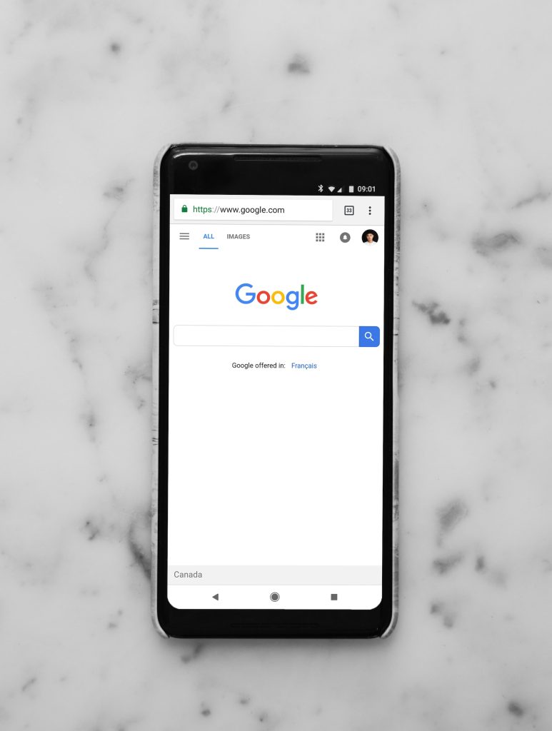 picture of phone with Google search bar pulled up