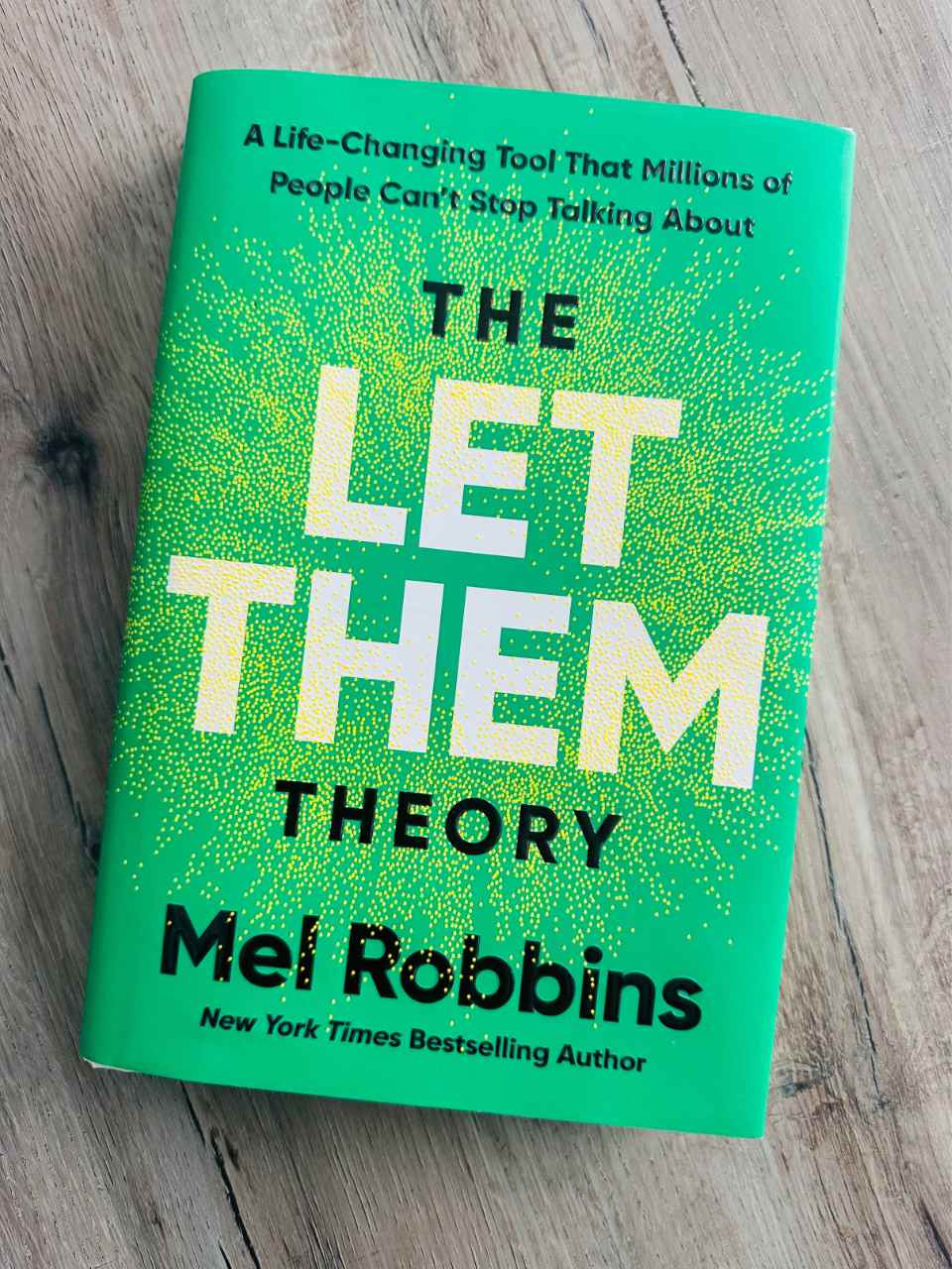 The Let Them Theory book on a wooden table